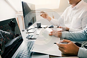 Two business stock brokers stress and looking at monitors displaying financial information