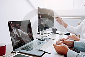 Two business stock brokers stress and looking at monitors displaying financial stock graph report information