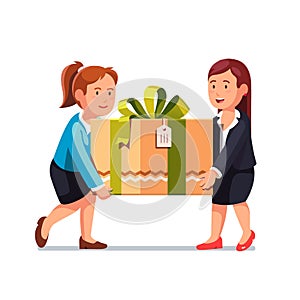 Two business woman carrying big holiday gift box