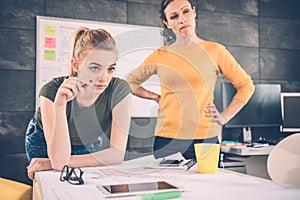 Two business woman contemplating photo