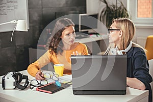Two business woman using computer photo