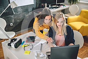 Two business woman working at the office photo