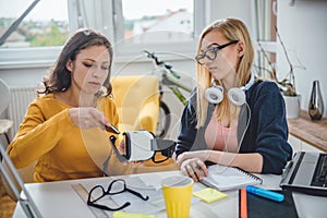 Two business woman working together at the office photo