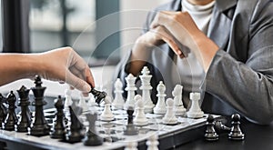 Two business women competitors playing chess board game, business competition concept, business plan to be the number one company