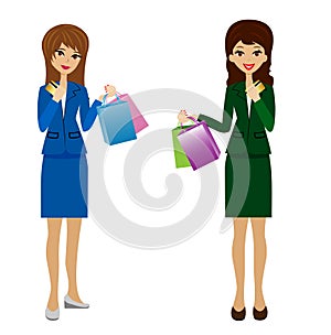 Two business women with credit cards and purchases in hands