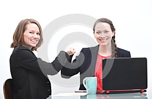 Two business women doing fist bump