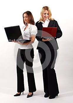 Two Business Women Standing with Laptops