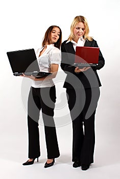 Two Business Women Standing with Laptops photo
