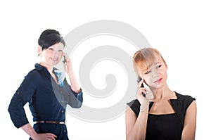 Two business women talking by cell phones