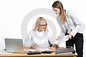 Two business women talking and signing document