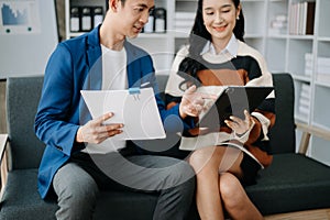 Two business workers talking on the smartphone and using laptop at the home office