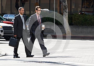 Two Businessman Chatting Whilst Crossing Street