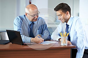 Two businessman discuss something, office shoot