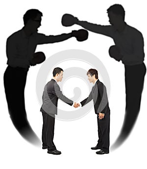 Two businessman handshake with fighting shadow