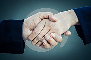 Two businessman handshake over grey background,partnership and success concept background