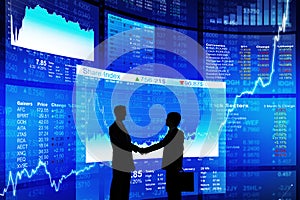 Two Businessman Handshaking with Blue Data Screen