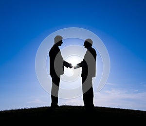 Two Businessman Handshaking on The Hill