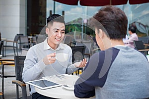 Two businessman having a casual meeting or discussion in the cit