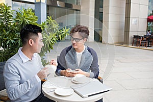 Two businessman having a casual meeting or discussion in the cit