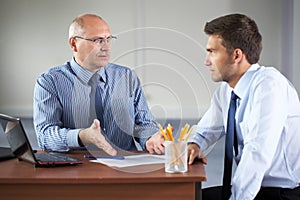 Two businessman with laptop, office
