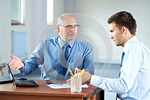 Two businessman with laptop, office