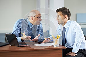 Two businessman with laptop, office shoot