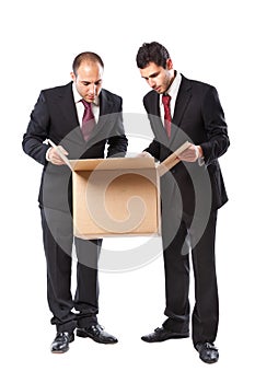 Two Businessman looking inside a box