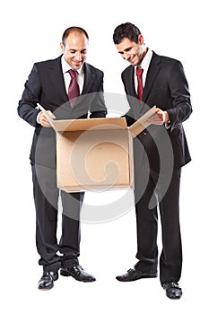 Two Businessman looking inside a box and smiling