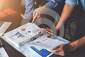 Two businessman planning strategy on desk with paperwork, Strategist team analyze data or information