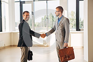 Two businessman shake hands