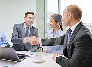 Two businessman shaking hands in office