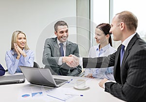 Two businessman shaking hands in office