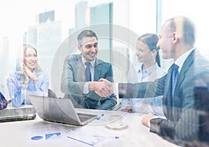 Two businessman shaking hands in office