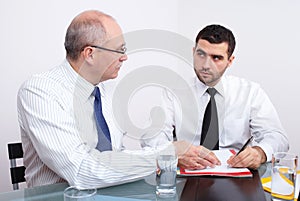 Two businessman sitting at table during meeting