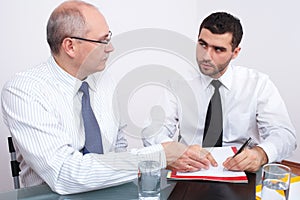 Two businessman sitting at table during meeting