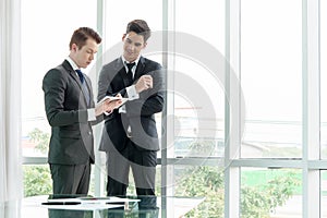 Two businessman using tablet during meeting