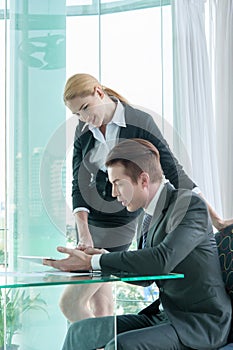 Two businessman using tablet during meeting