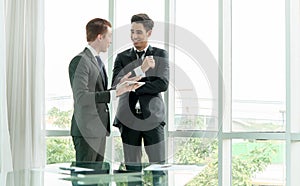 Two businessman using tablet during meeting