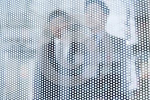 Two businessmen behind a glass wall looking out, unrecognizable faces