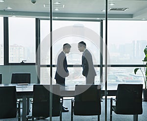 Two Businessmen Bowing to Each Other