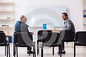 Two businessmen in the classroom in pandemic concept