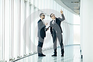 Two businessmen dicussing building changing