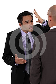 Two businessmen disagreeing