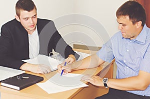 Two businessmen discussing a contract