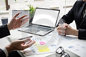 Two businessmen are discussing about earnings on a graph to plan investments