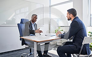 Two businessmen discussing during recruitment in office