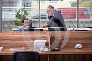 Two businessmen employees working in the office