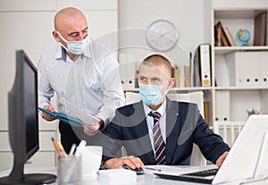 Two businessmen in fase masks discussing new ideas