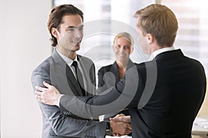 Two businessmen handshaking