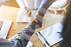 Two businessmen handshaking in meeting after final project agreement deal done